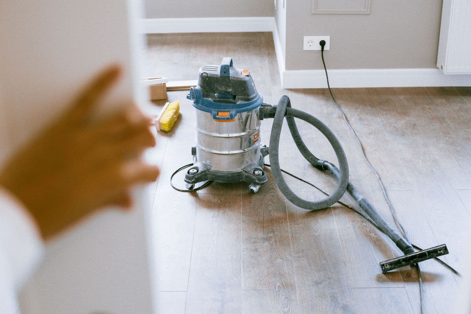 Industrial vacuum on the floor of a newly renovated, unfurnished room